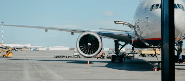 A luxurious limo waiting outside the busy terminal of O'Hare International Airport.