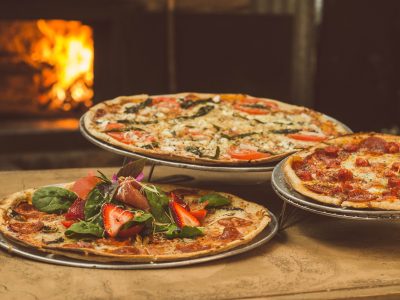 A delicious spread at Spacca Napoli Pizzeria, showcasing the renowned Neapolitan-style pizzas that mark Chicago's culinary excellence on the global map.