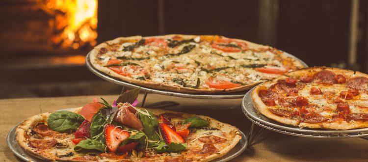 A delicious spread at Spacca Napoli Pizzeria, showcasing the renowned Neapolitan-style pizzas that mark Chicago's culinary excellence on the global map.