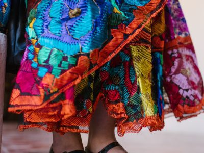 A vibrant Hispanic Heritage Month celebration with diverse communities enjoying the festivities and a luxury party bus in the background.