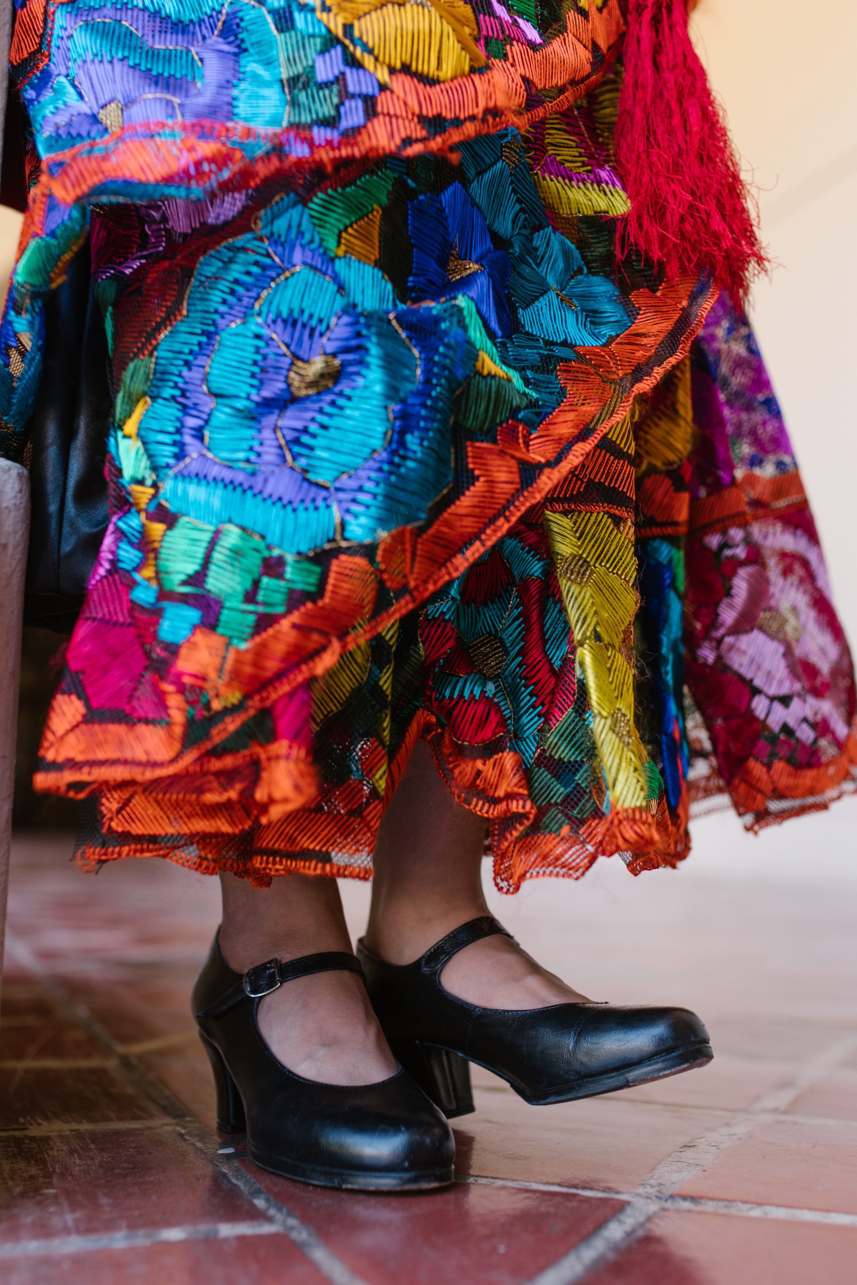 A vibrant Hispanic Heritage Month celebration with diverse communities enjoying the festivities and a luxury party bus in the background.