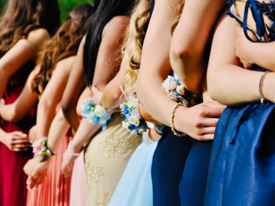 Teens dressed elegantly stepping off a luxury party bus in Chicago.